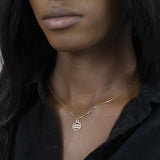 Model Wearing Charming Zodiac Aquarius Minimalist Solid Gold Pendant By Jewelry Lane