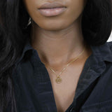 Model Wearing Charming Zodiac Aquarius Minimalist Solid Gold Pendant By Jewelry Lane