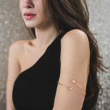 Model Wearing Beautiful Adjustable Arrow Style Solid Gold Armband Bangle By Jewelry Lane