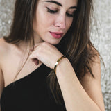 Model Wearing Beautiful Solid Gold Open Cuff Bangle by Jewelry Lane