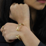 Model Wearing Beautiful Solid Gold Greek Column Bangle by Jewelry Lane