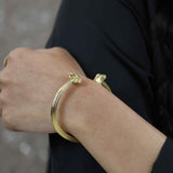 Model Wearing Beautiful Solid Gold Greek Column Bangle by Jewelry Lane