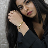 Model Wearing Smart And Chic Open Plain Cuff Solid Gold Bangle By Jewelry Lane
