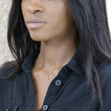 Model Wearing Charming Zodiac Taurus Minimalist Solid Gold Pendant By Jewelry Lane