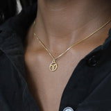Model Wearing Charming Zodiac Aries Minimalist Solid Gold Pendant By Jewelry Lane