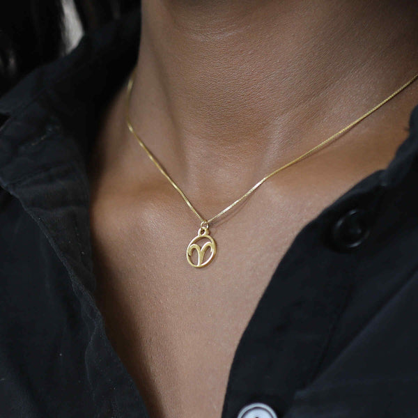 Model Wearing Charming Zodiac Aries Minimalist Solid Gold Pendant By Jewelry Lane