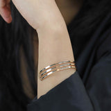 Model Wearing Three Ring Solid Gold Cuff Bangle by Jewelry Lane