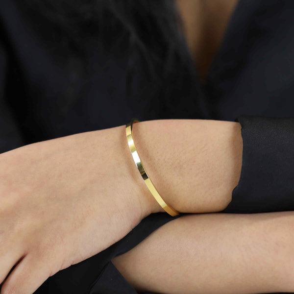 Model Wearing Beautiful Timeless Solid Gold Open Cuff Bangle by Jewelry Lane