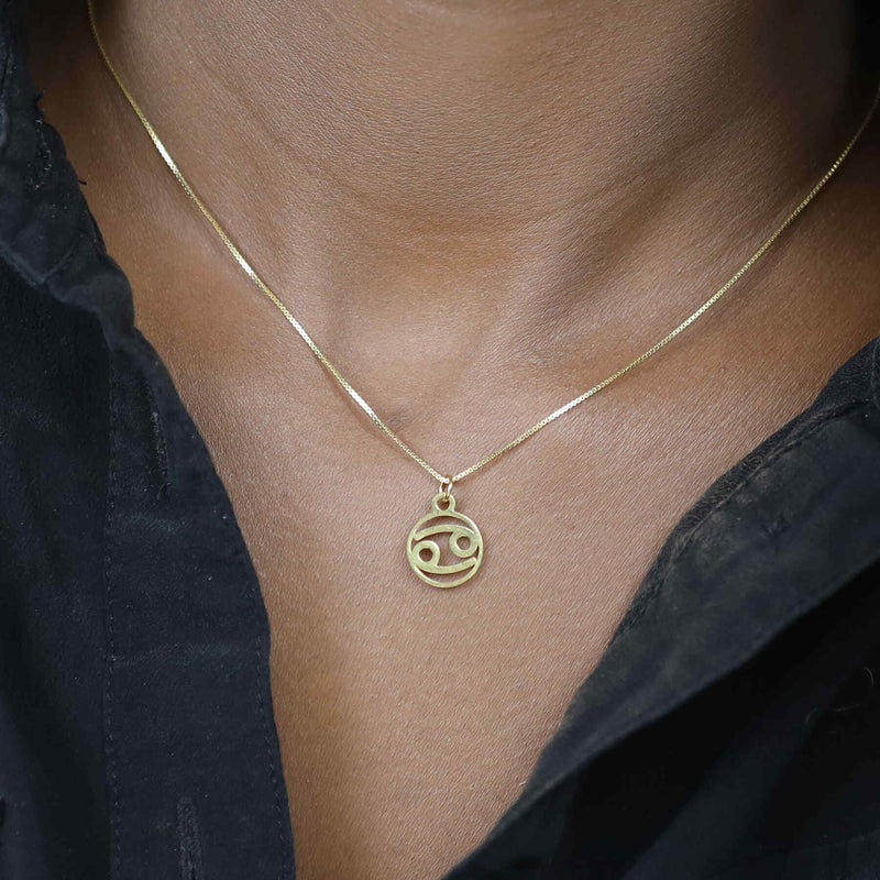 Model Wearing Charming Zodiac Cancer Minimalist Solid Gold Pendant By Jewelry Lane