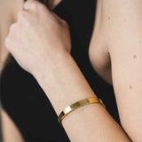 Model Wearing Beautiful Solid Gold Open Cuff Bangle by Jewelry Lane