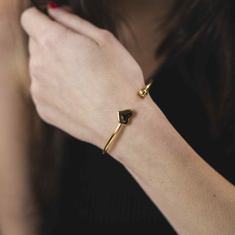 Model Wearing Beautiful Round Single Heart Solid Gold Cuff Bangle by Jewelry Lane