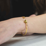 Model Wearing Beautiful Round Single Heart Solid Gold Cuff Bangle by Jewelry Lane