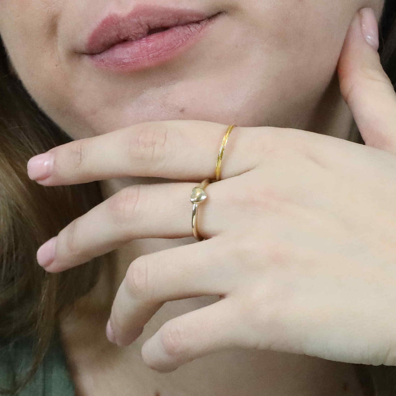 Model Wearing Beautiful Simple Heart Stacker Solid Gold Ring By Jewelry Lane