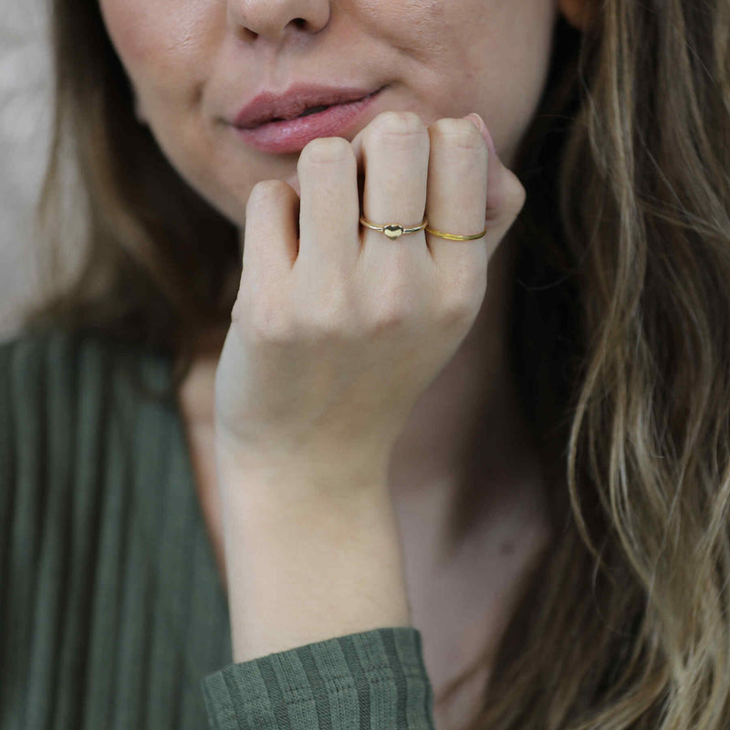 Model Wearing Beautiful Simple Heart Stacker Solid Gold Ring By Jewelry Lane