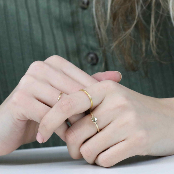 Model Wearing Beautiful Simple Heart Stacker Solid Gold Ring By Jewelry Lane