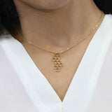 Model Wearing Beautiful Honeycomb Inspired Solid Gold Pendant By Jewelry Lane