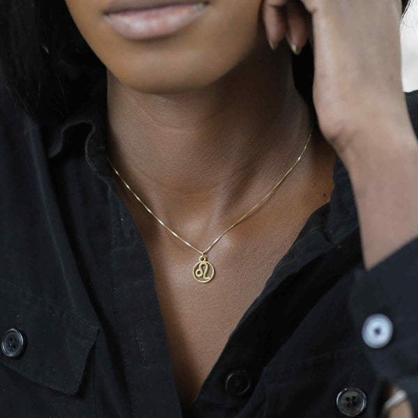 Model Wearing Charming Zodiac Leo Minimalist Solid Gold Pendant By Jewelry Lane