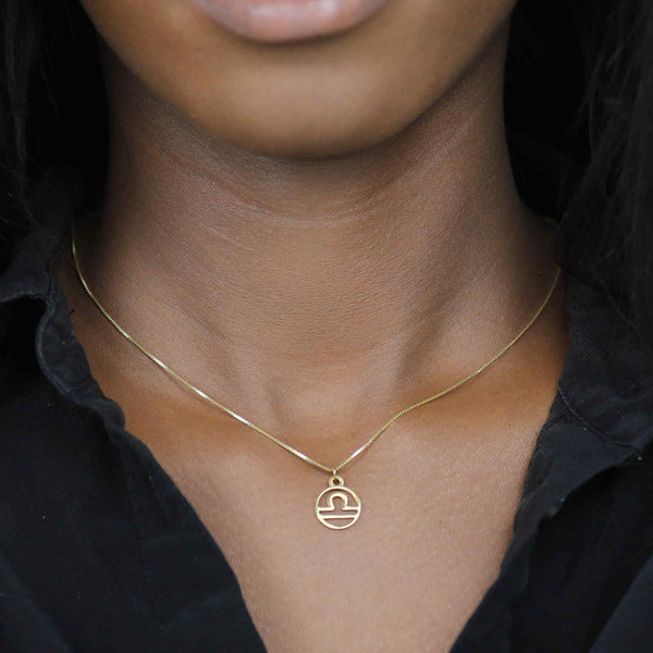 Model Wearing Charming Zodiac Libra Minimalist Solid Gold Pendant By Jewelry Lane