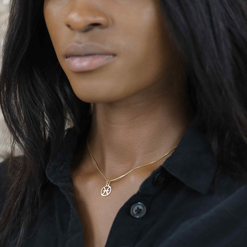 Model Wearing Charming Zodiac Pisces Minimalist Solid Gold Pendant By Jewelry Lane