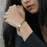 Model Wearing Smart And Chic Open Plain Cuff Solid Gold Bangle By Jewelry Lane