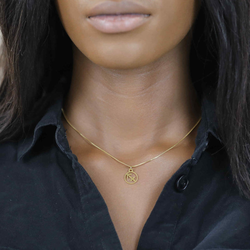 Model Wearing Charming Zodiac Sagittarius Minimalist Solid Gold Pendant By Jewelry Lane