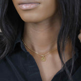 Model Wearing Charming Zodiac Sagittarius Minimalist Solid Gold Pendant By Jewelry Lane