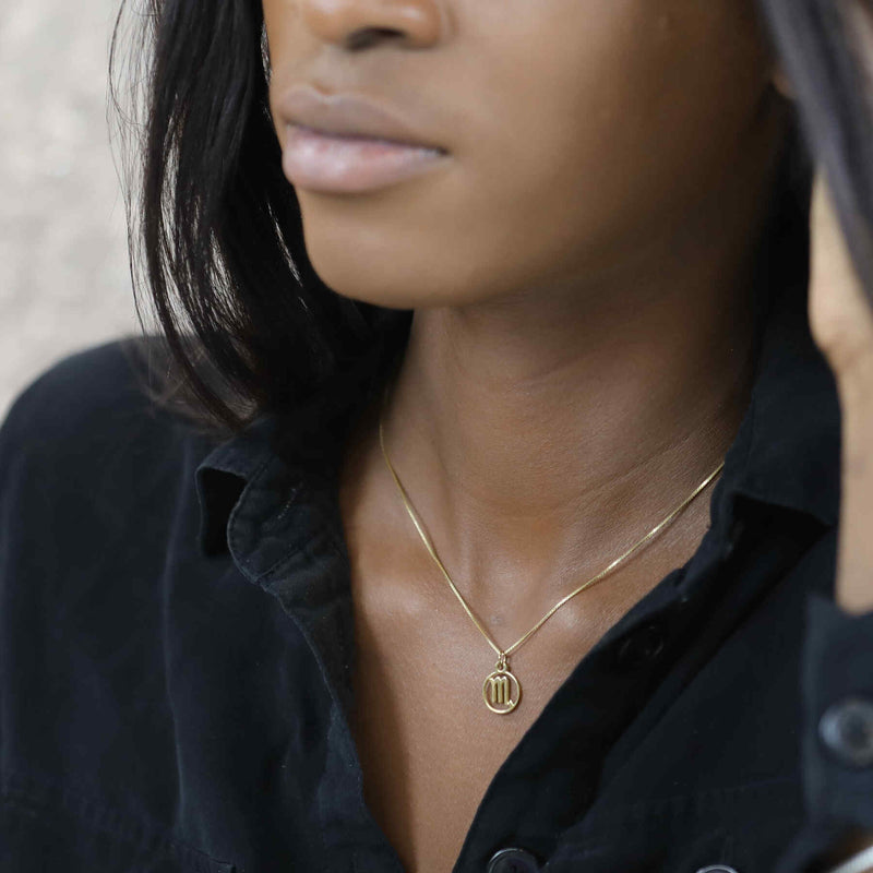 Model Wearing Charming Zodiac Scorpio Minimalist Solid Gold Pendant By Jewelry Lane