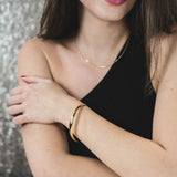 Model Wearing Beautiful Timeless Polished Solid Gold Bangle by Jewelry Lane